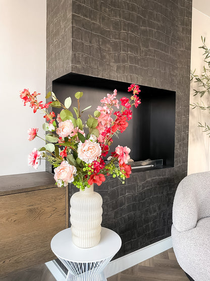 Geribbelde vaas met oranje tinten boeket